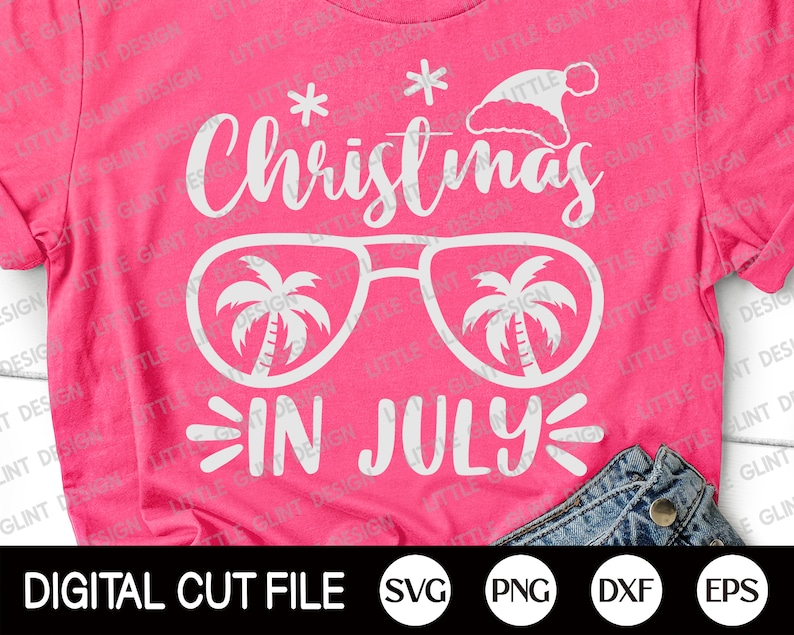 May include: Pink t-shirt with white text that reads "Christmas in July" with a pair of sunglasses with palm trees inside the lenses. The text is in a fun, whimsical font.