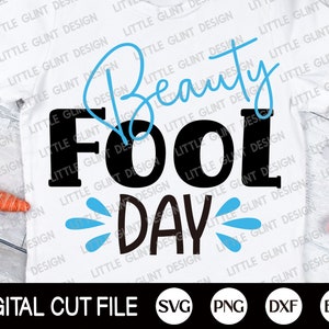 May include: A white t-shirt with a black and blue design that says "Beauty Fool Day" with water droplets. The design is on a white t-shirt with a blue background. The text is in a bold font.