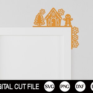 May include: A digital cut file design featuring a gingerbread house, a gingerbread person, and a Christmas tree, all decorated with snowflakes. The design is perfect for creating festive door decorations or other crafts.