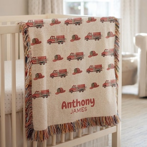 May include: A white ceramic mug with a black handle and the text "But First, Coffee" in a bold, black font. The mug is set against a neutral background, highlighting its simple design.