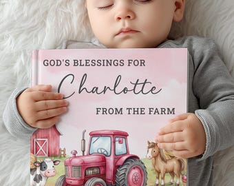 May include: A hardcover book titled God's Blessings for Charlotte From the Farm, featuring a pink watercolor background, a red tractor, a cow, a horse, a pig, and a duckling in a farm setting, held by a sleeping infant in a gray long-sleeve shirt.