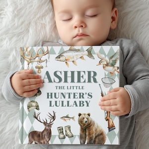 May include: A personalized children's book titled "Asher The Little Hunter's Lullaby." The cover features illustrations of a deer, bear, fish, and hunting-themed elements. The book is held by a baby.