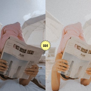 May include: A person wearing a pink towel on their head is reading a newspaper with the word "Arts" on the front page. The person is lying on a white blanket on a beach.