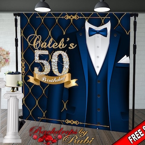 May include: A blue and gold backdrop with a tuxedo design. The number 50 is decorated with rhinestones and the text "Caleb's 50th Birthday" is written in gold.