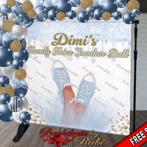 May include: A blue and white backdrop with gold glitter and the text "Dimi's Twenty Twice Sneaker Ball". The backdrop features a pair of blue sneakers with white laces and a white background.