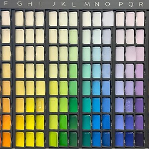 May include: A colour chart with 8 rows and 26 columns of small, square paint samples. The colours are arranged in a rainbow spectrum, starting with pink and ending with black. The chart is labelled with letters from A to X across the top and numbers from 1 to 8 down the side.