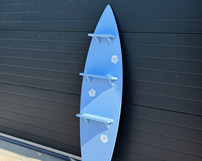 Decorative Surfboard Shelf with Hibiscus Accents in pastel blue