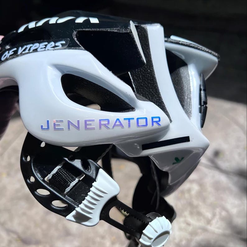 A close-up view of a bicycle helmet with the brand name "JENERATOR" printed on it.