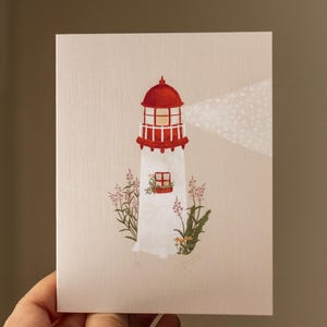 Carte de souhaits avec Illustration de phare côtier avec fleurs