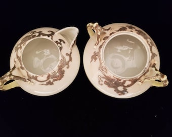 Vintage creamer- en suikerpotset met zilveren inlegmotieven