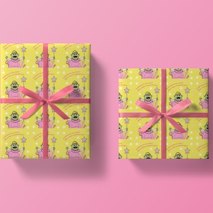 May include: Two yellow gift wrap rolls with a green character holding a pink wand and stars. The character is wearing a pink dress and has the text "Could she be any sweeter? What a wonderful girl!" repeated on the wrap.