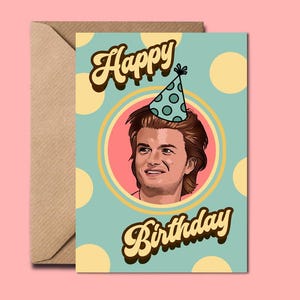May include: A birthday card featuring a portrait of a man wearing a party hat. The card has a light blue background with yellow polka dots and the words "Happy Birthday" in a retro font. An envelope is included.