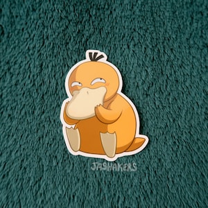 May include: A yellow and orange cartoon duck with a beak and a surprised expression. The duck is holding a piece of bread in its beak. The duck is sitting on a green fuzzy surface.