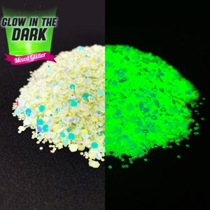 May include: A close-up of a pile of mixed glitter that glows in the dark. The glitter is a light green color in the light and glows a bright green in the dark. The text "Glow in the Dark" and "Mixed Glitter" is visible in the image.