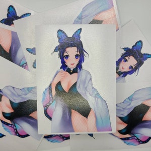 May include: A sticker featuring an anime character with blue hair and a butterfly on her head. She is wearing a white robe and a black bodysuit. The sticker has a holographic finish.