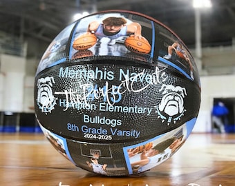 May include: A black and white basketball with a custom design. The basketball features photos of basketball players, the school name "Memphis Naveil", "Hampton Elementary", "Bulldogs", "8th Grade Varsity", and the year "2024-2025". The basketball is on a wooden floor.