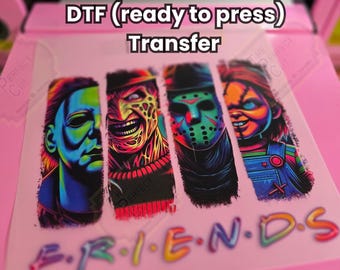 May include: A DTF (ready to press) transfer sheet featuring four horror movie characters: Michael Myers, Freddy Krueger, Jason Voorhees, and Chucky. The word "FRIENDS" is below the characters. The text reads "*works on all fabric material and color(s)*".