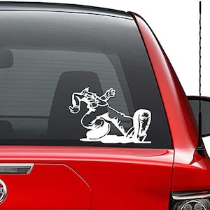 May include: White vinyl decal of a person ice skating. The decal is on the back window of a red car.