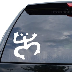 May include: White vinyl decal of a stylized frog on a black car window. The decal is a popular symbol of Puerto Rico.