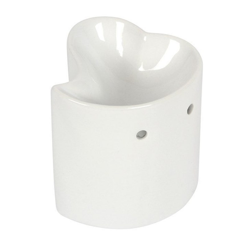 May include: White ceramic heart-shaped wax warmer with three small holes on the side.