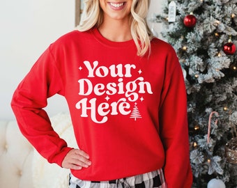 May include: Red sweatshirt with white text that says "Your Design Here" with a small white Christmas tree graphic.