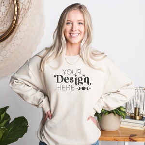 May include: A beige sweatshirt with the text "YOUR Design HERE..." in black.