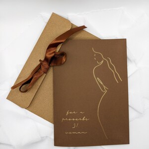 May include: A brown card with a gold outline of a woman and the text "for a proverbs 31 woman" in gold lettering.