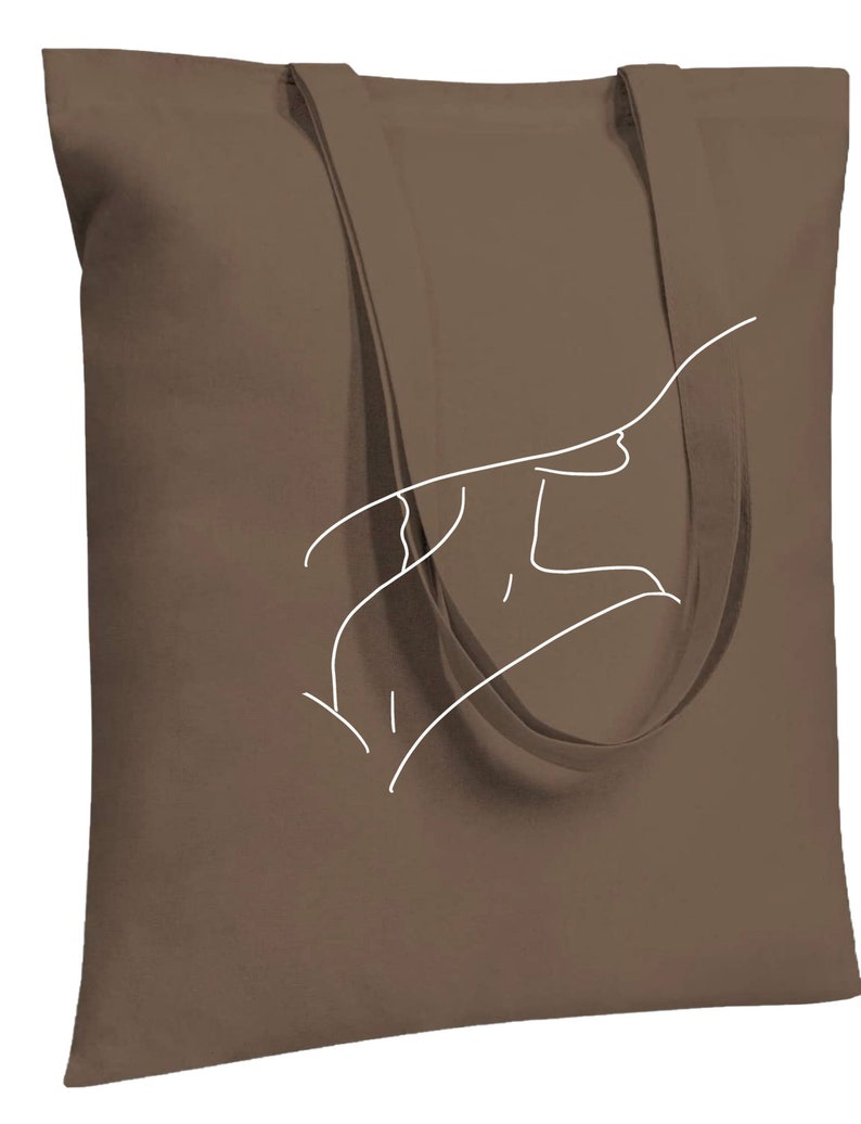May include: A brown canvas tote bag with white outline of a hand drawing on the front.