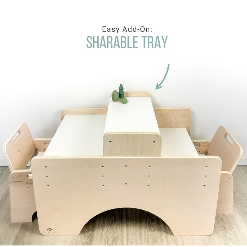May include: A wooden table with two chairs and a removable tray. The table is light brown and has a white surface. The tray is labeled "Sharable Tray".