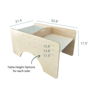 May include: A wooden table with a curved top and adjustable height options. The table is 33.8 inches wide, 17.5 inches tall, and 21.9 inches deep. The table height options are 15.8 inches, 13.8 inches, and 11.5 inches.