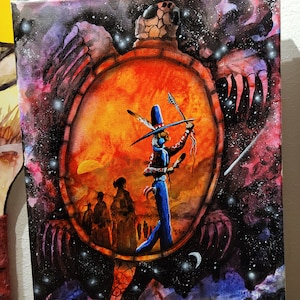 May include: A colourful canvas painting showcases a Native American figure in blue and red attire, with a bow and arrow. The artwork is set within a circular frame against a fiery orange backdrop, surrounded by a starry, cosmic sky. The artist's signature is visible.