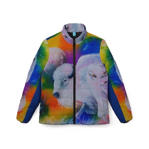 May include: A colorful puffer jacket with a white buffalo and a rainbow background. The jacket has a zipper closure and a stand-up collar.