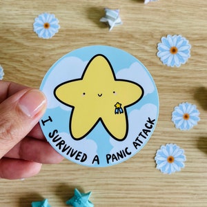 May include: A blue and white sticker with a yellow star and the text "I survived a panic attack".