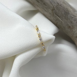 Handmade and dainty jewelry made in Montreal by Piper & Pearl Jewelry. Feminine, modern and delicate, perfect for a gift for her. Collections of costume, vermeil and fine jewelry. Art deco inspired marquise zirconia gold band ring.