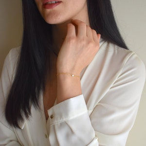 Handmade and dainty jewelry made in Montreal by Piper & Pearl Jewelry. Feminine, modern and delicate, perfect for a gift for her. Collections of costume, vermeil and fine jewelry. Dainty and delicate rectangle zirconia gold bracelet.