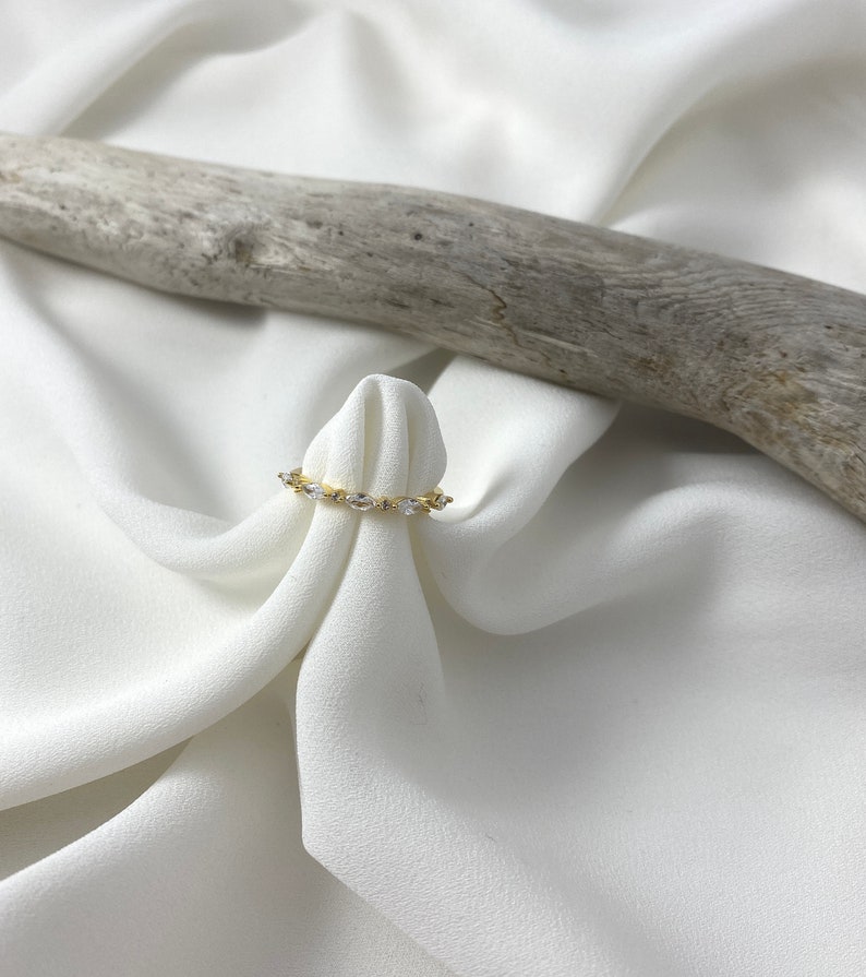 Handmade and dainty jewelry made in Montreal by Piper & Pearl Jewelry. Feminine, modern and delicate, perfect for a gift for her. Collections of costume, vermeil and fine jewelry. Art deco inspired marquise zirconia gold band ring.