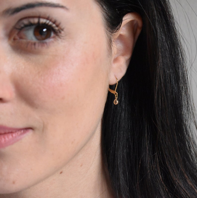 Handmade and dainty jewelry made in Montreal by Piper & Pearl Jewelry. Feminine, modern and delicate, perfect for a gift for her. Collections of costume, vermeil and fine jewelry. Dainty gold dangle drop earrings with delicate zirconia.