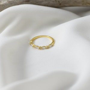 Handmade and dainty jewelry made in Montreal by Piper & Pearl Jewelry. Feminine, modern and delicate, perfect for a gift for her. Collections of costume, vermeil and fine jewelry. Art deco inspired marquise zirconia gold band ring.