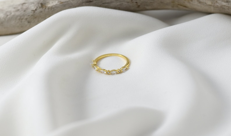 Handmade and dainty jewelry made in Montreal by Piper & Pearl Jewelry. Feminine, modern and delicate, perfect for a gift for her. Collections of costume, vermeil and fine jewelry. Art deco inspired marquise zirconia gold band ring.