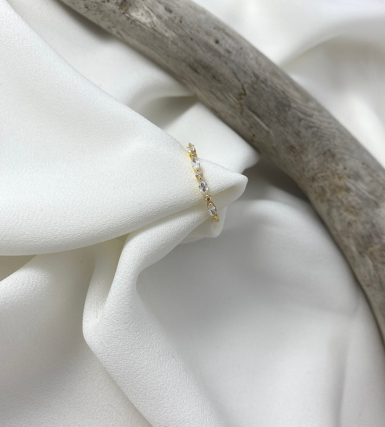 Handmade and dainty jewelry made in Montreal by Piper & Pearl Jewelry. Feminine, modern and delicate, perfect for a gift for her. Collections of costume, vermeil and fine jewelry. Art deco inspired marquise zirconia gold band ring.