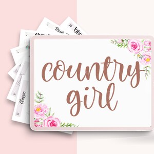 May include: A digital tablet screen displaying the text "country girl" in a copper-colored font. The text is surrounded by a watercolor floral design with pink flowers and green leaves.