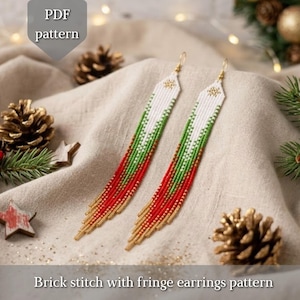 May include: A pair of long beaded fringe earrings featuring a white, green, red, and gold color gradient pattern. The earrings are designed with a brick stitch technique and include a PDF pattern label at the top and bottom.