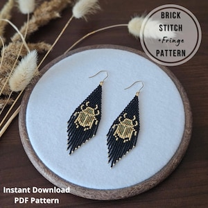 May include: Black beaded earrings with a fringe design and gold-colored hooks. Each earring features a gold and green scarab beetle design. The earrings are displayed on a white surface with the text "BRICK STITCH + FRINGE PATTERN" and "Instant Download PDF Pattern".