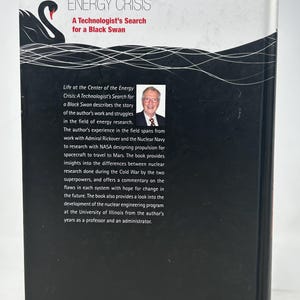 May include: The back cover of a book titled "Life at the Center of the Energy Crisis: A Technologist's Search for a Black Swan." The cover is black with white text and a graphic of a black swan. The book is published by World Scientific.