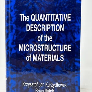 May include: A hardcover book titled "The QUANTITATIVE DESCRIPTION of the MICROSTRUCTURE of MATERIALS" with a blue cover. The author's names, Krzysztof Jan Kurzyńdowski and Brian Ralph, are printed at the bottom of the cover.