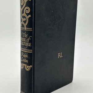 May include: A hardcover book titled "The Tree of Culture" by Ralph Linton. The book has a black cover with gold lettering and decorative elements. The spine features the title and author's name. The cover has an embossed design and the initials "RL".