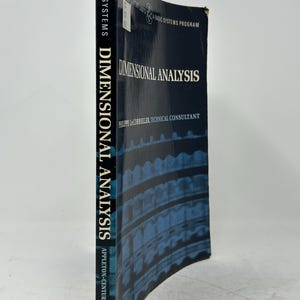 May include: A hardcover book titled "DIMENSIONAL ANALYSIS" by Philippe LeCorbeiller. The book has a dark blue cover with white text and a patterned design. The spine reads "BASIC SYSTEMS DIMENSIONAL ANALYSIS APPLETON-CENTURY-CROFTS".