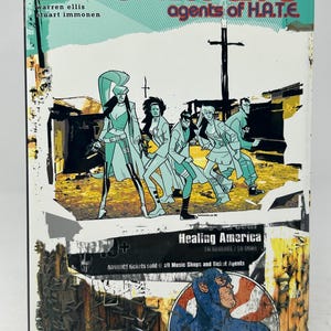 May include: A comic book cover for "Nextwave: Agents of H.A.T.E." features a group of stylized figures in action poses. The cover includes text such as "Marvel Premiere Edition" and "Healing America". The color palette includes teal, red, and yellow.