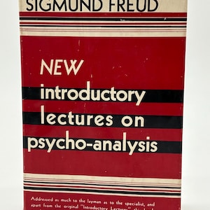 May include: A vintage book titled "New Introductory Lectures on Psycho-Analysis" by Sigmund Freud. The book has a red cover with black and white stripes and white text. The book's cover also includes a brief description.