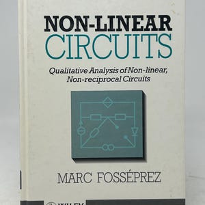 May include: A book titled "NON-LINEAR CIRCUITS" by Marc Fosséprez, published by Wiley. The cover is white with black and teal text and a teal circuit diagram. The subtitle reads "Qualitative Analysis of Non-linear, Non-reciprocal Circuits." The book is on a black stand.